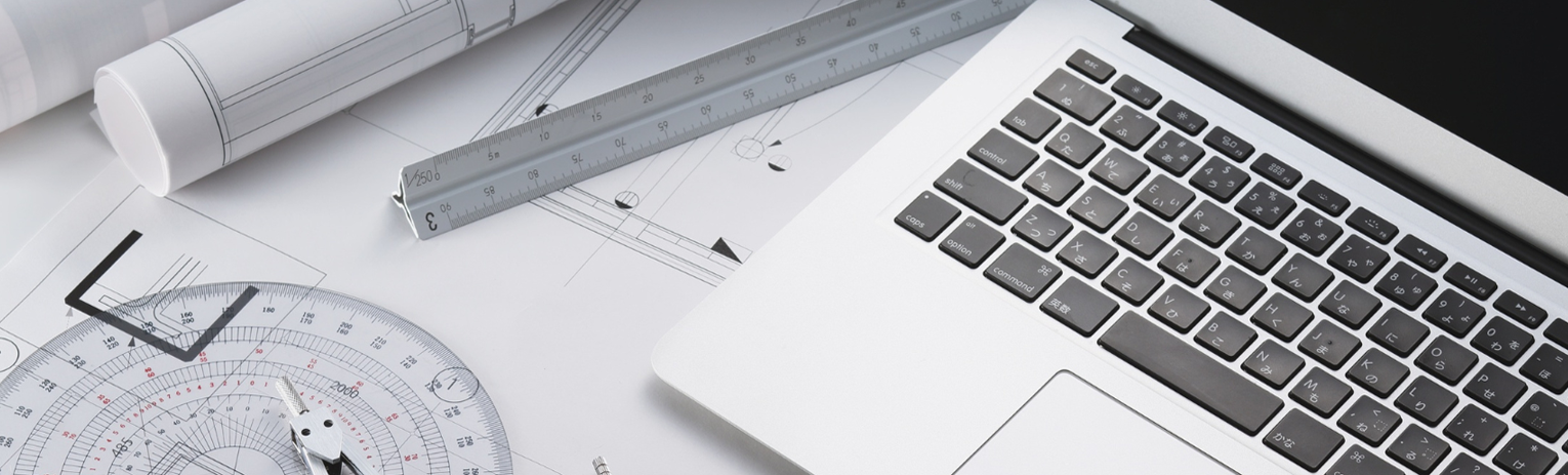 Two people pointing at a document on a table, one holding a pen